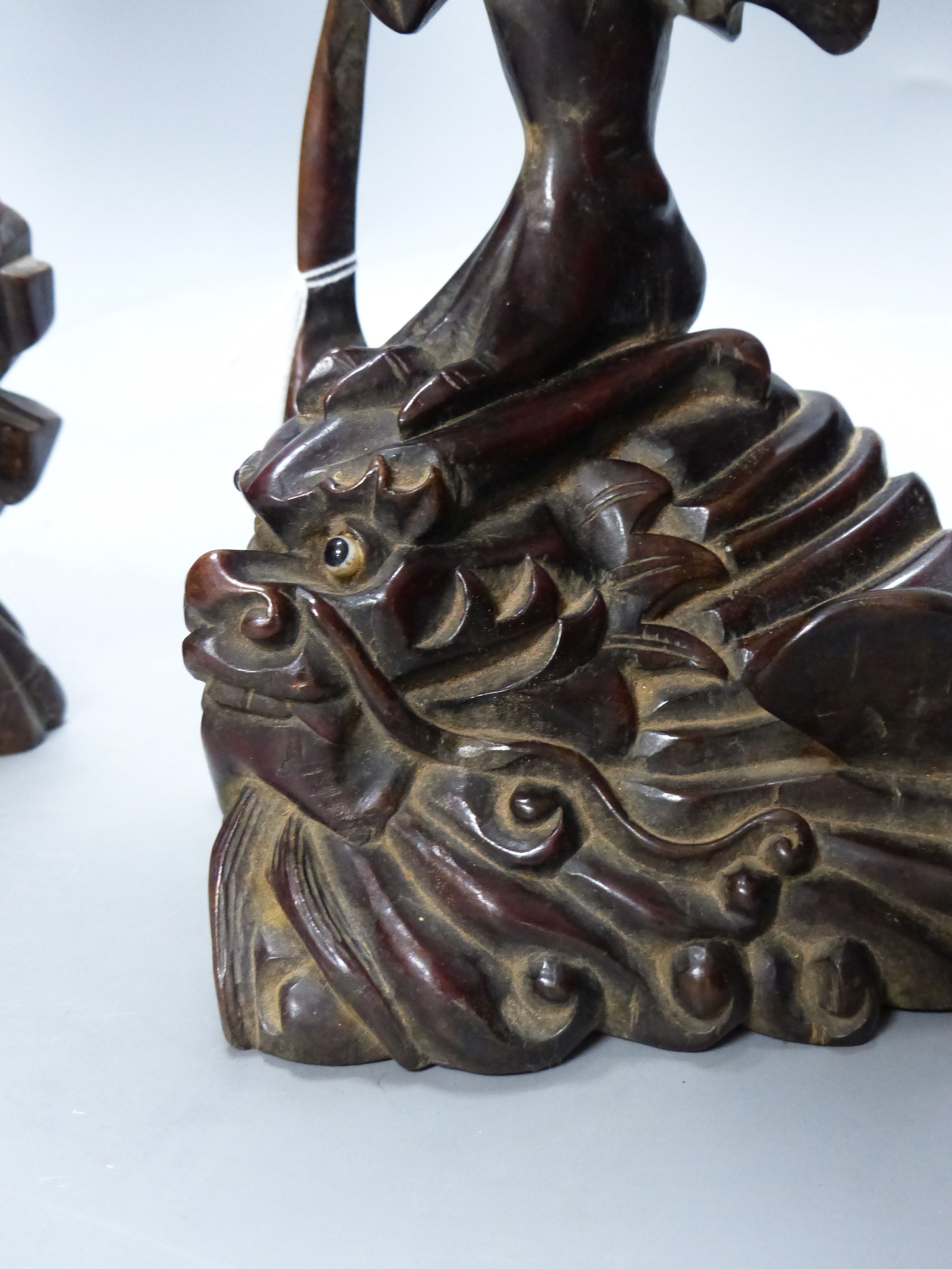 Two early 20th century Chinese hardwood figures of a demon and a fisherman, tallest 61cm